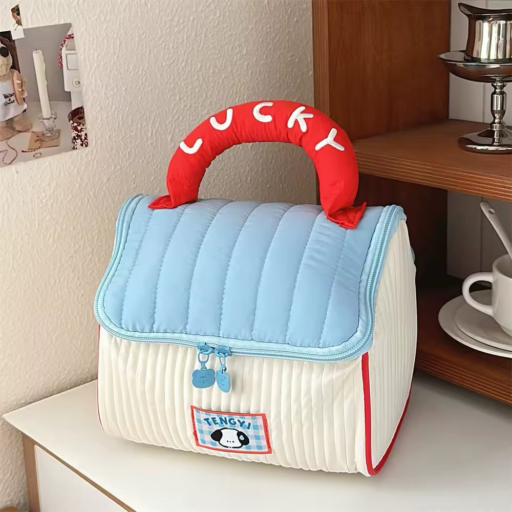 Waterproof beauty organizer shaped like a house, with soft carrying handle and spacious interior for cosmetics