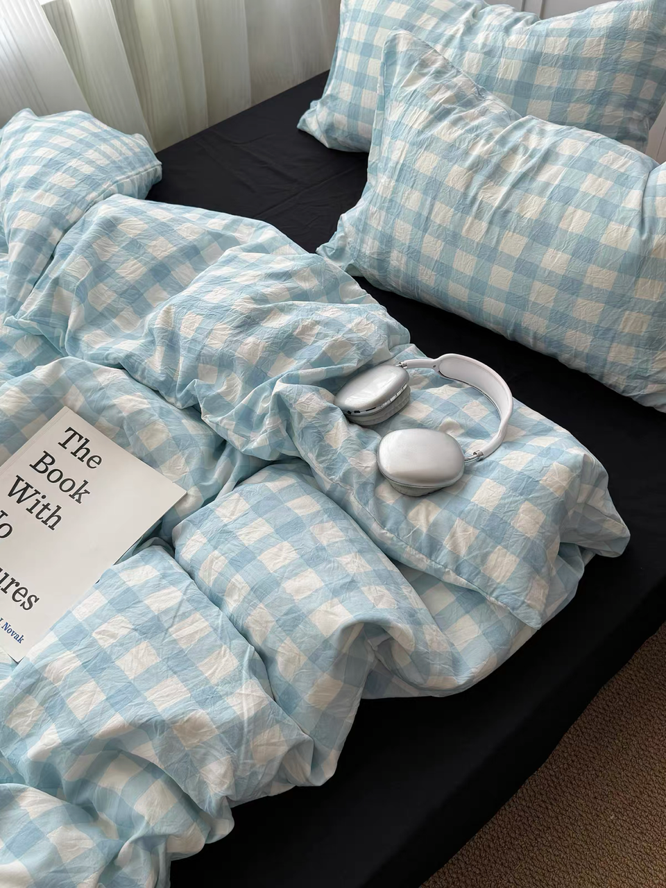Close view of a light blue gingham duvet cover set with matching checked pillowcases