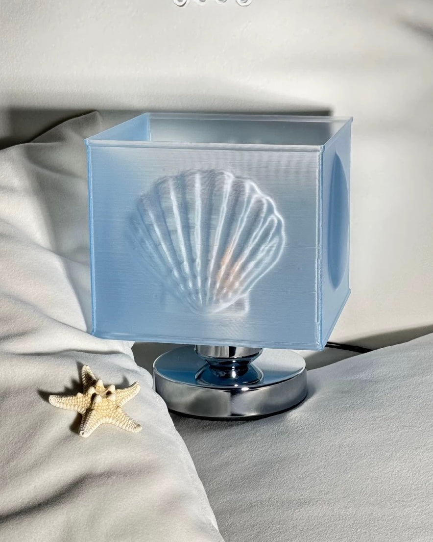 Decorative lamp with shell design on a soft fabric background