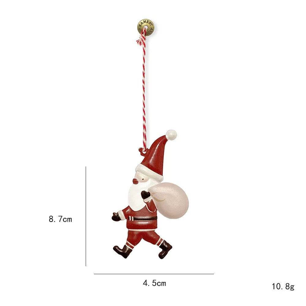 Metal Christmas ornaments include this red Santa with a white sack, black boots and a hanging cord.