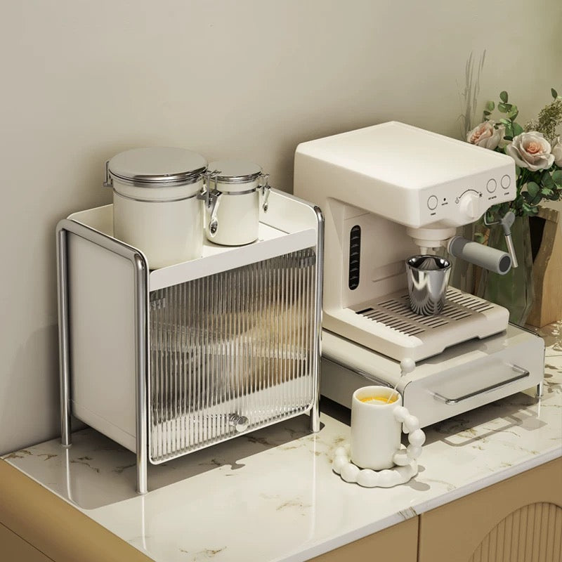 Coffee capsule drawer organizer under the machine, keeping pods, tea bags and essentials neatly hidden for a clean kitchen setup.