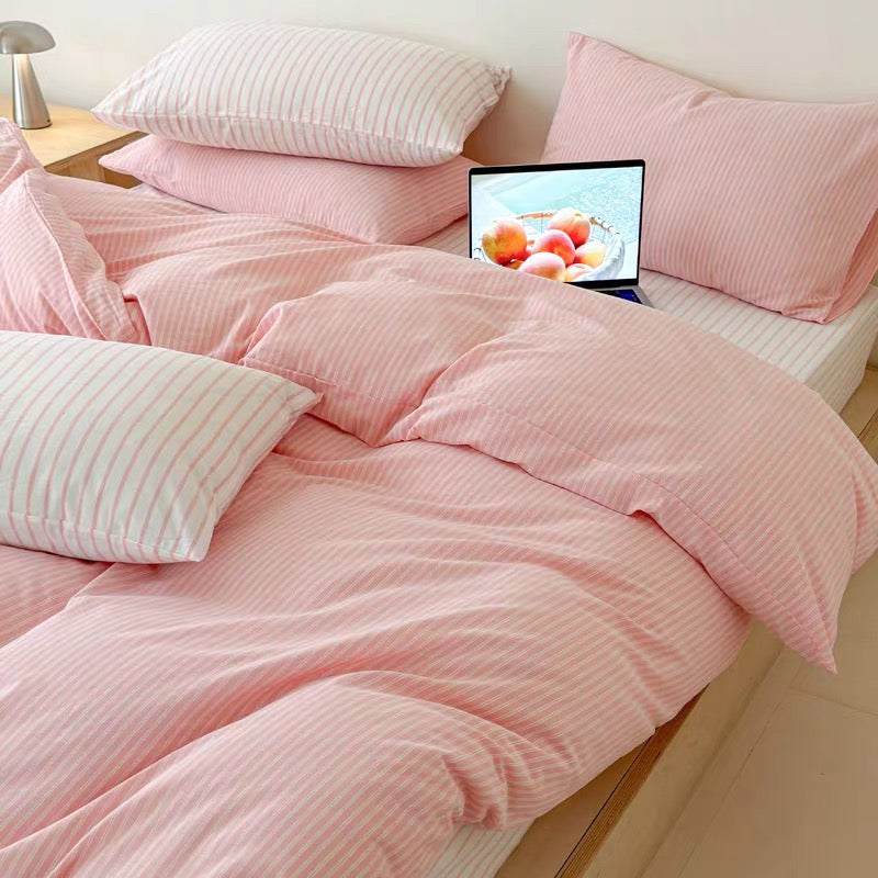 Minimalist blush striped duvet cover paired with matching flat sheet and cotton pillowcases for everyday comfort.