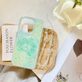 Clear phone case with floral design on a wooden tray