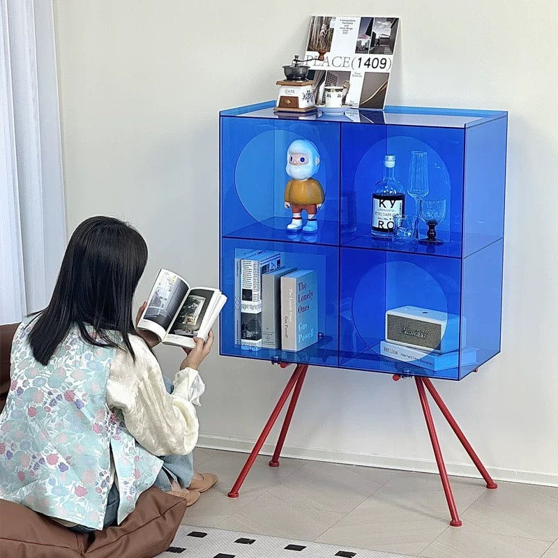 Modern acrylic display cabinet used for collectible figurines and decorative objects in stylish interior