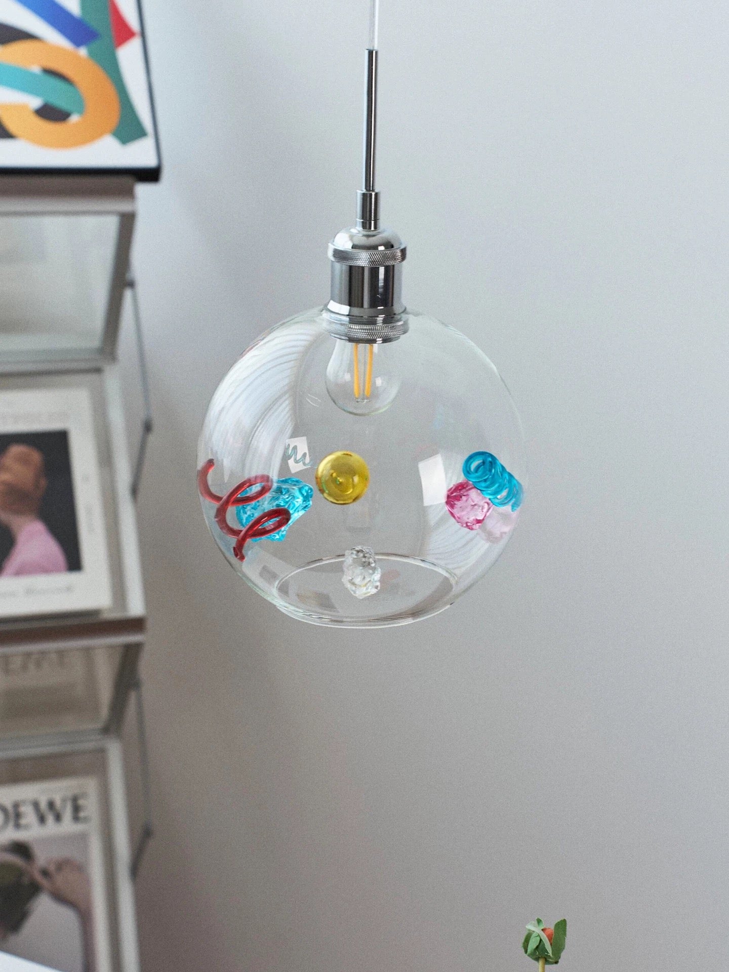 Decorative light bulb with colorful designs on a white wall