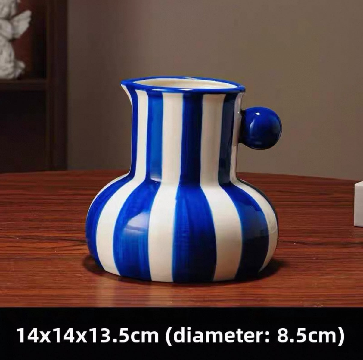 Blue and white striped vase on a wooden surface with dimensions displayed.