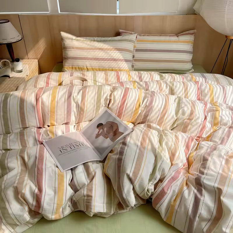 Striped bedding with a magazine on a bed in a bedroom setting