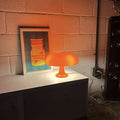 Chic mushroom table lamp in white and orange. Decorative vintage light for bedrooms, desks, and cozy home interiors.