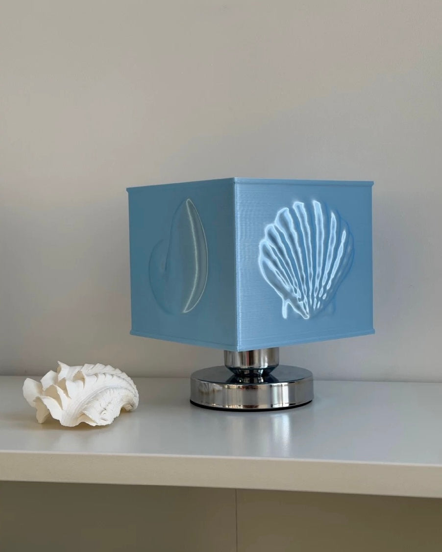 Decorative lamp with shell design on a soft fabric background