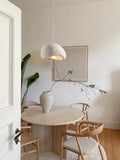 Gray dome pendant lamp in living room with blinds and curtains

