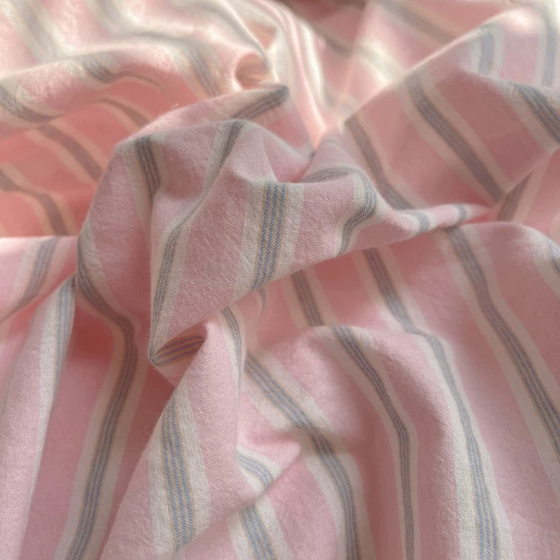 Close-up of pink fabric with subtle stripes