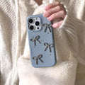 Hand holding a blue phone case with star designs against a white textured background