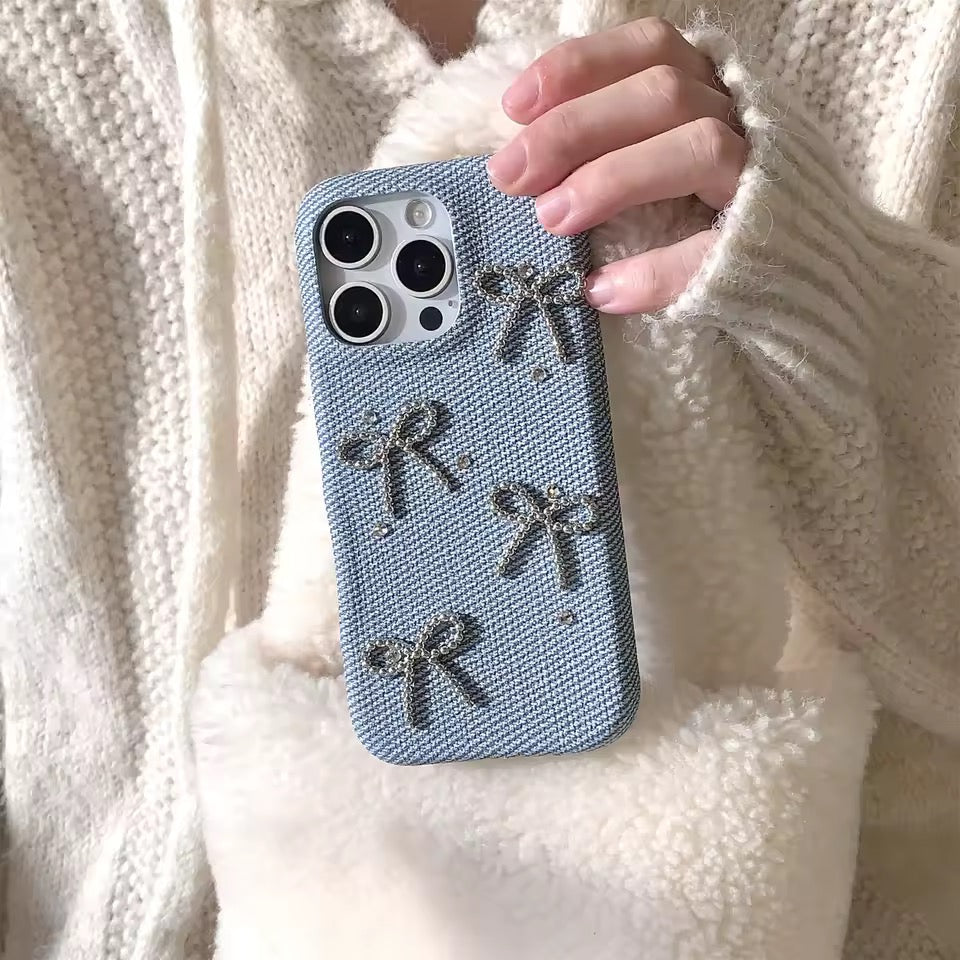 Hand holding a blue phone case with star designs against a white textured background