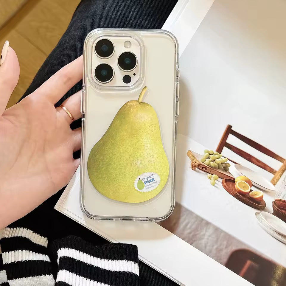 Phone case with a pear design held by a hand, with a blurred background of a table setting.