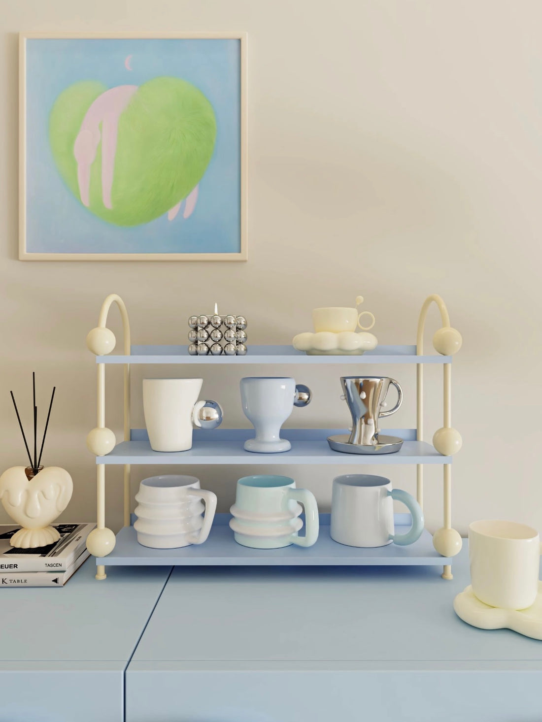 Blue perfume display shelf with cream arches and ball details holds cups and saucers across open tiers.