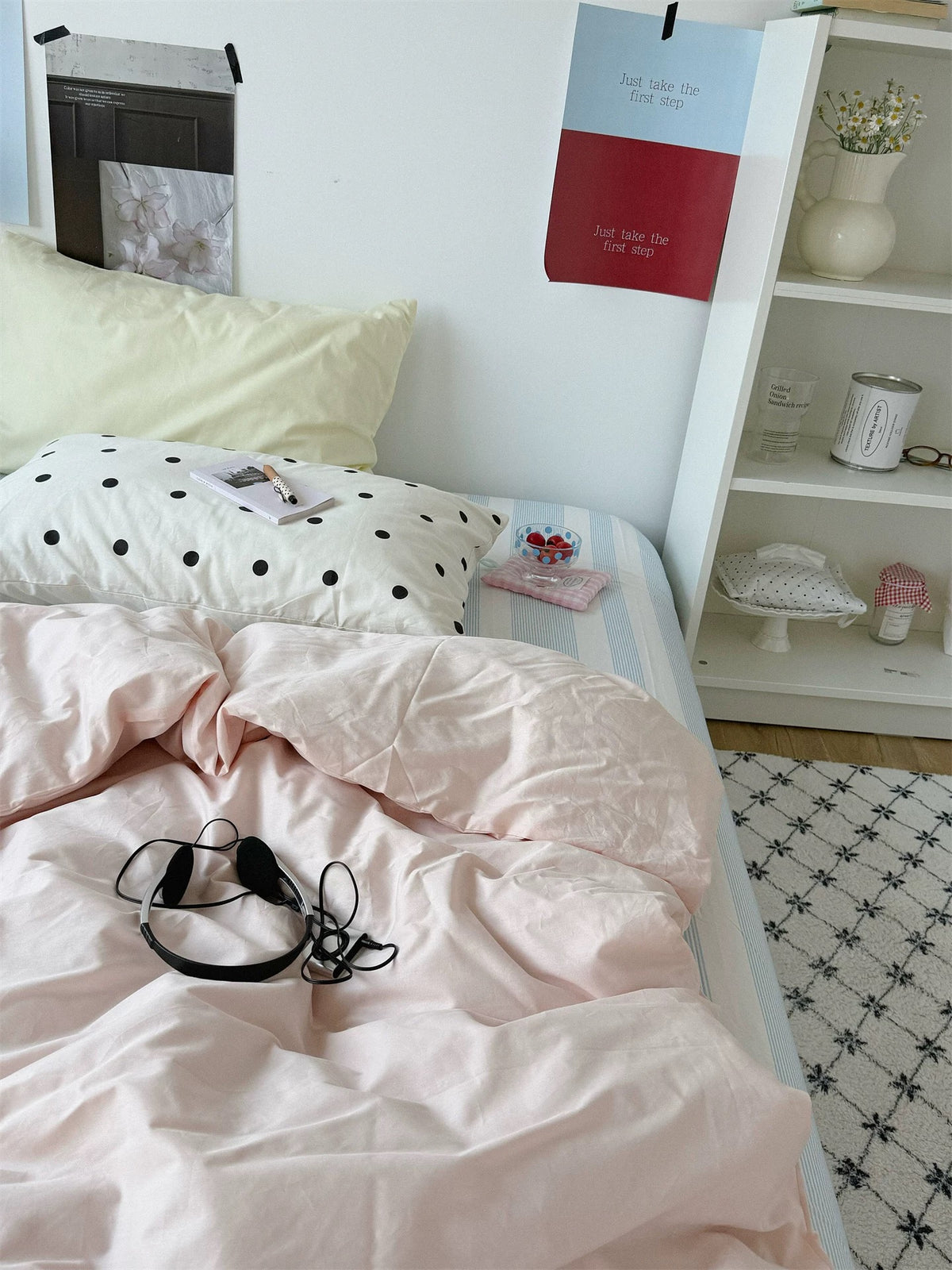 Small black dots on white contrast with a yellow pillowcase and the plain pink duvet cover.