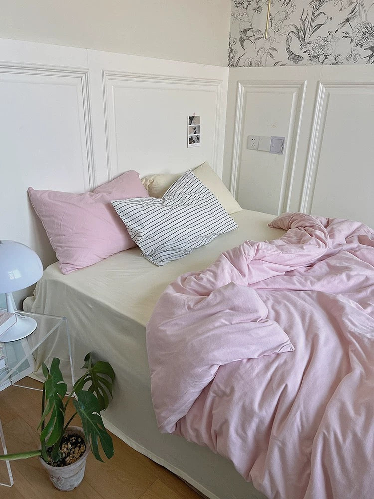 Pale pink jersey knit duvet cover set with cream sheet and contrasting pillowcases
