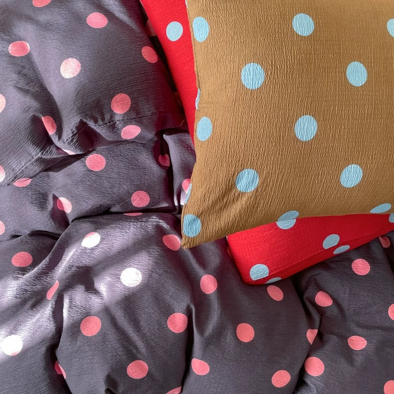Modern dark polka dot bedding styled for college dorm room cozy aesthetic setup