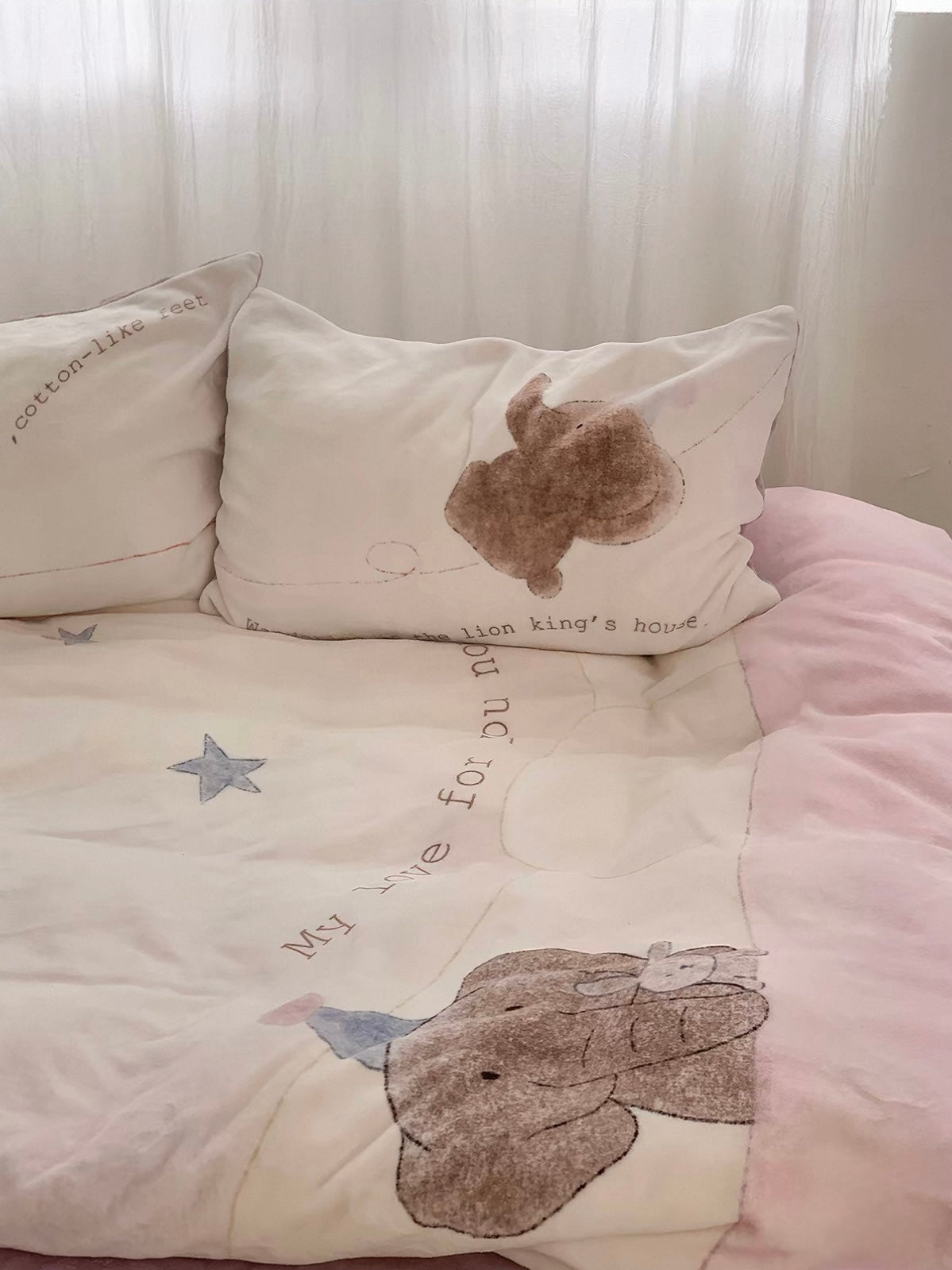 A closer bed view shows the elephant near the pink border and matching elephant pillowcase.