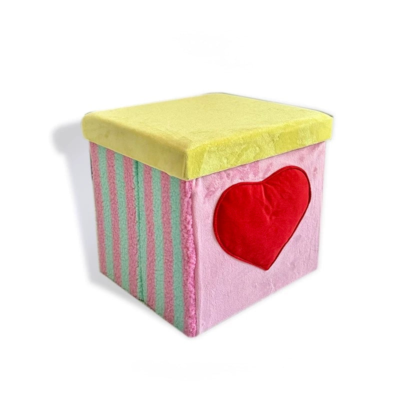 Pink heart velvet storage stool on a white background