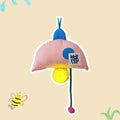 Toy with a striped umbrella and yellow ball on a beige background