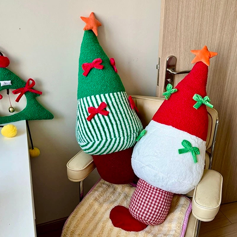 Plush red and green Christmas tree pillows styled together for a festive seating area