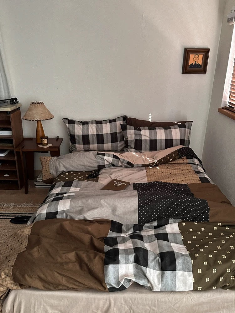 Preppy dorm bedding look with brown and gray checks across the bed
