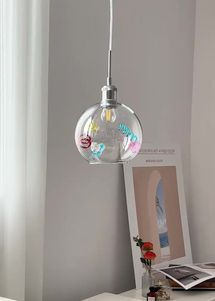 Colorful glass pendant light hanging from ceiling