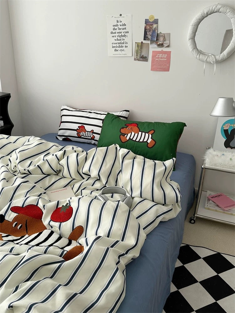 Bed with cartoon-themed bedding and pillows in a room with a checkered floor.