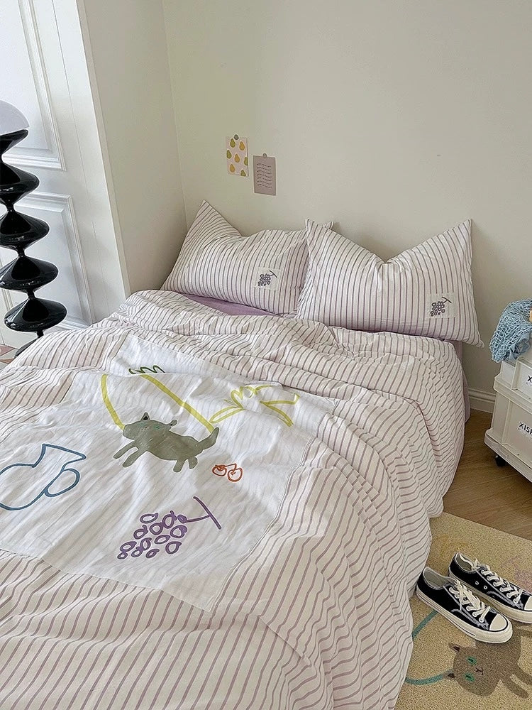 Purple applique duvet cover set with lilac stripes and cartoon patch motifs on a full bed.