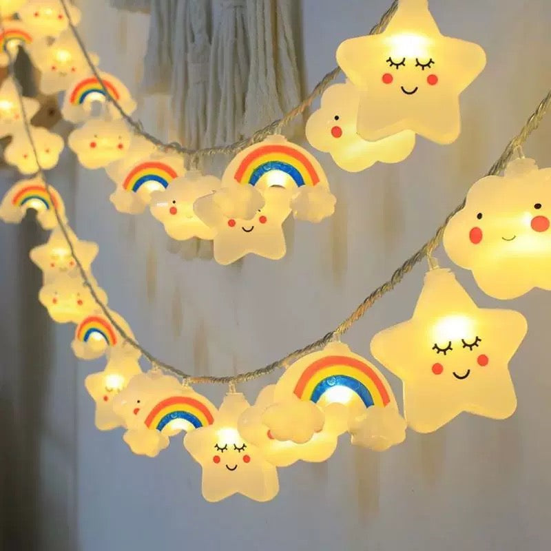 String lights with star and rainbow designs on a neutral background