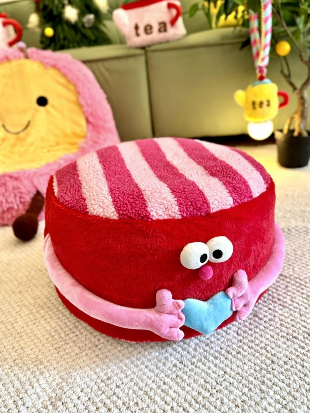 Red cute ottoman with striped top styled in a colorful bedroom