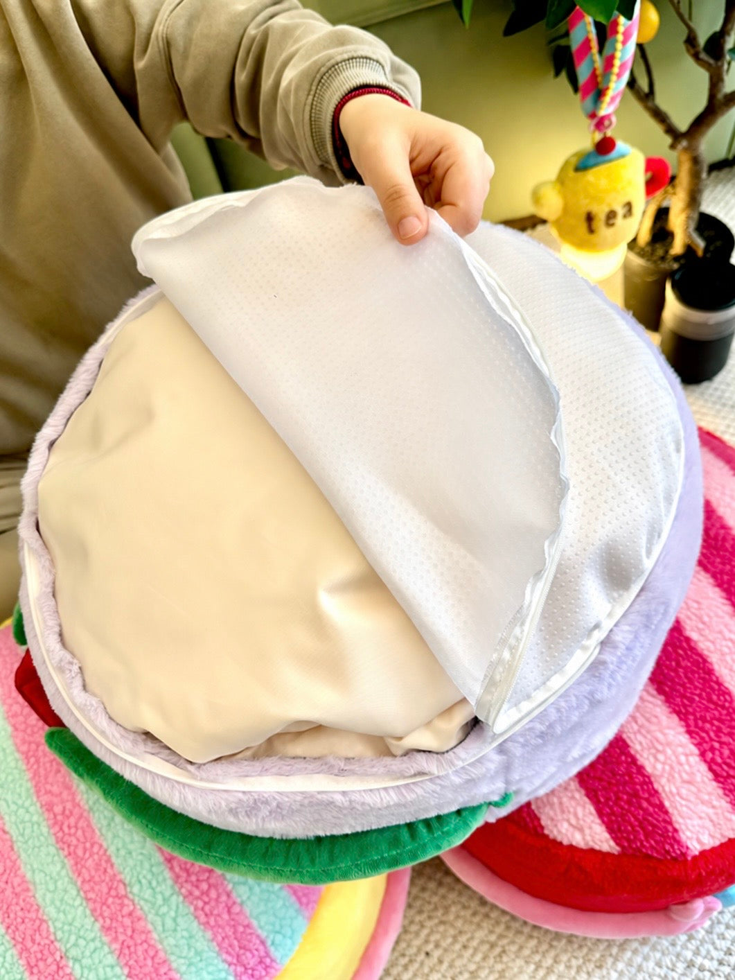 Plush ottoman opened to show the removable washable cover and inner fill bag