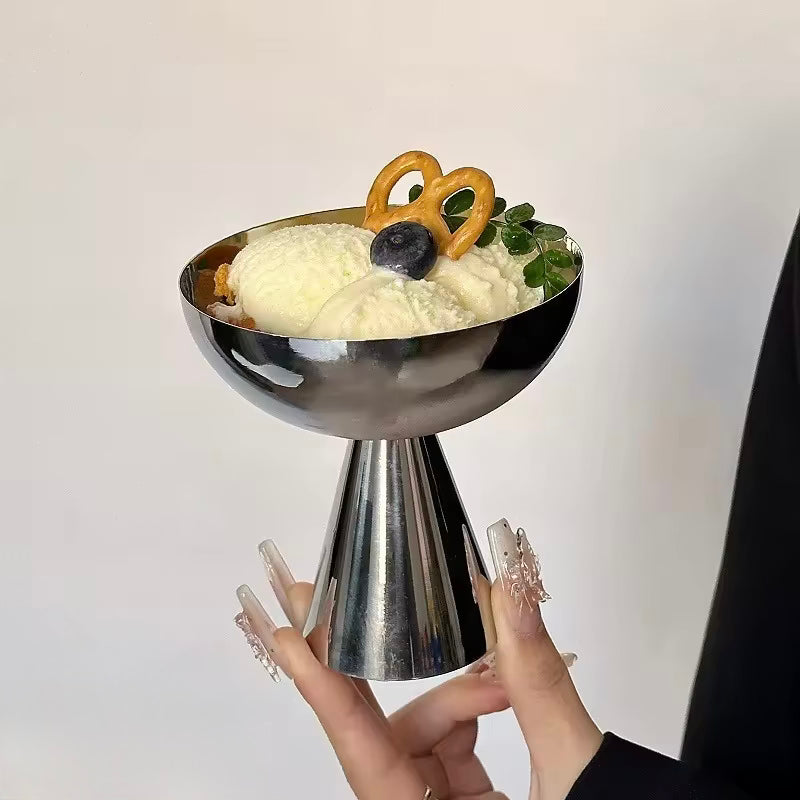 Metallic bowl with dessert on a plain background