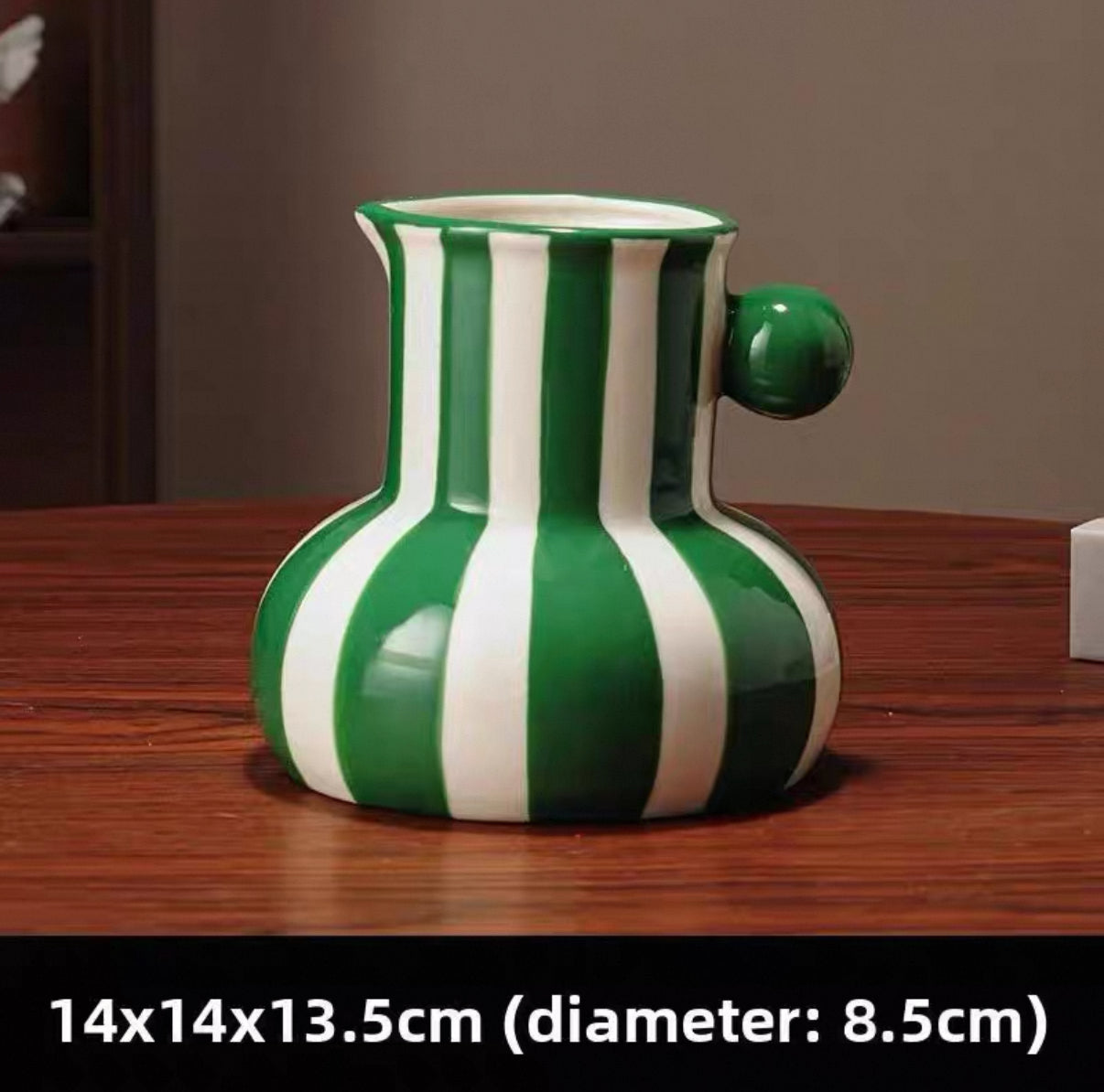 Green and white striped vase on a wooden surface with dimensions displayed.