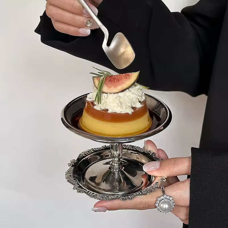 Person holding a dessert with a spoon on a white background