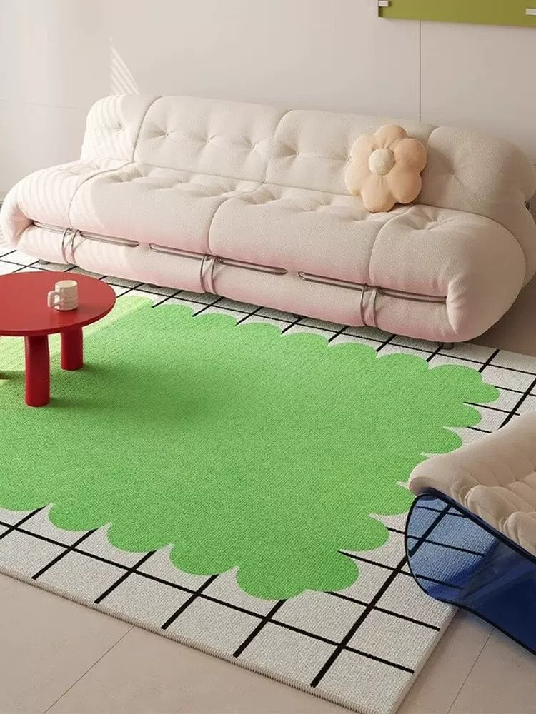 Green abstract rug on a tiled floor with a white sofa and red table in the background.