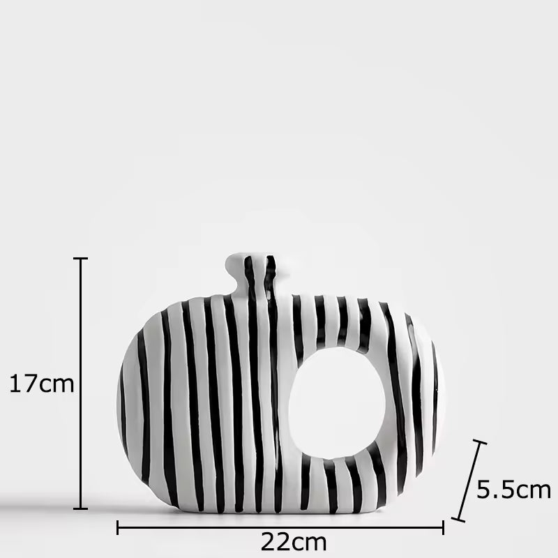 Black and white striped pouch with measurements on a light gray background