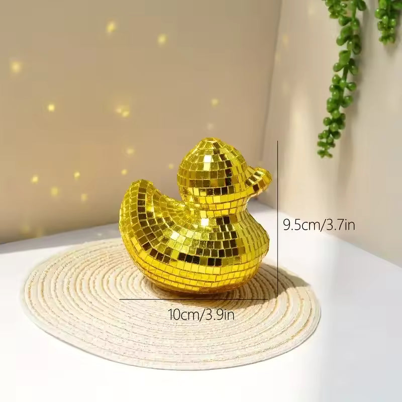Gold disco duck on a white surface with measurements indicated