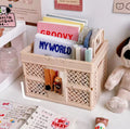 The Feelz organizer box shown folded flat beside a laptop and books