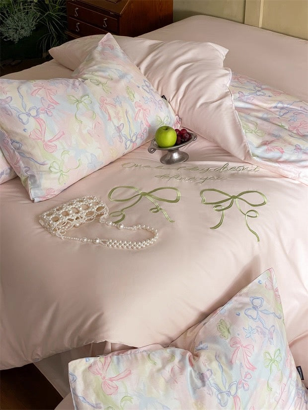 Bedding set with floral patterns and embroidery on a bed.