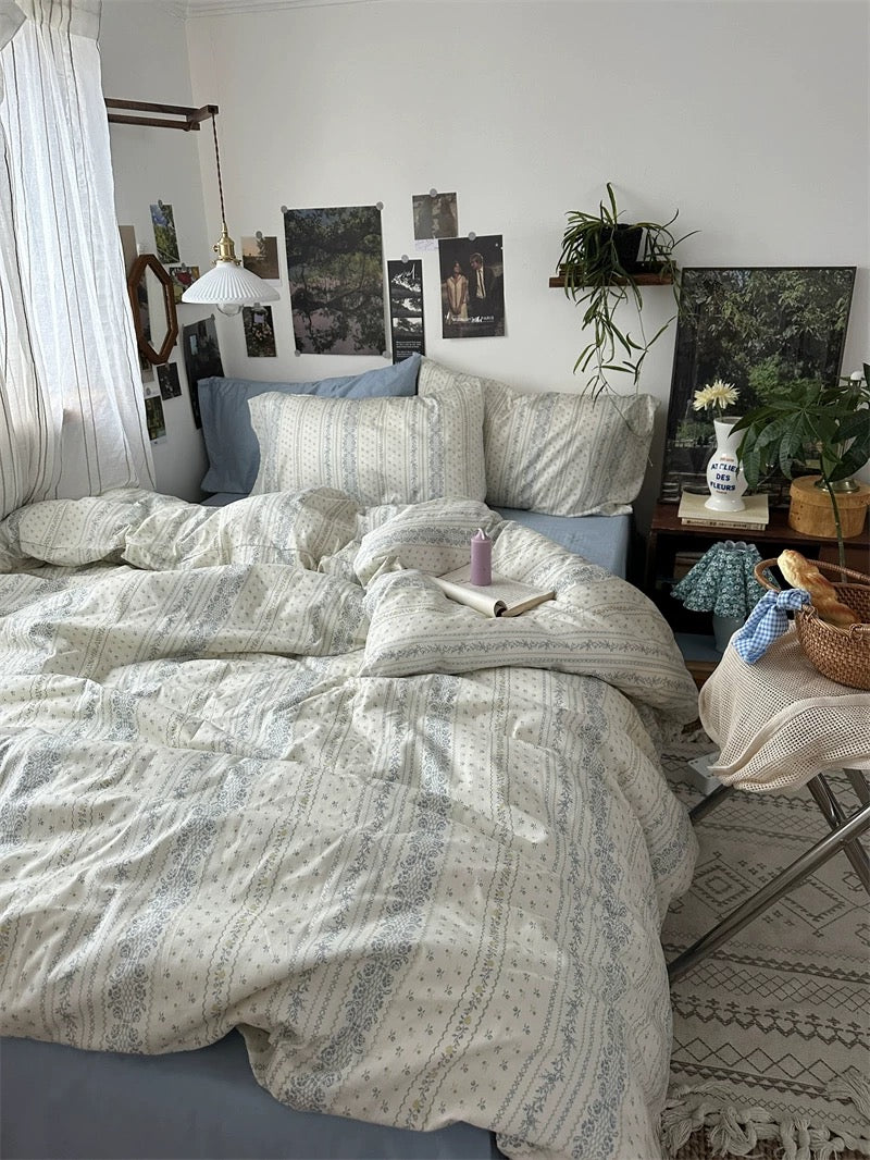 Soft floral cotton bedding displayed with neutral decor, botanical accents, and warm wooden bedside furniture indoors beautifully.