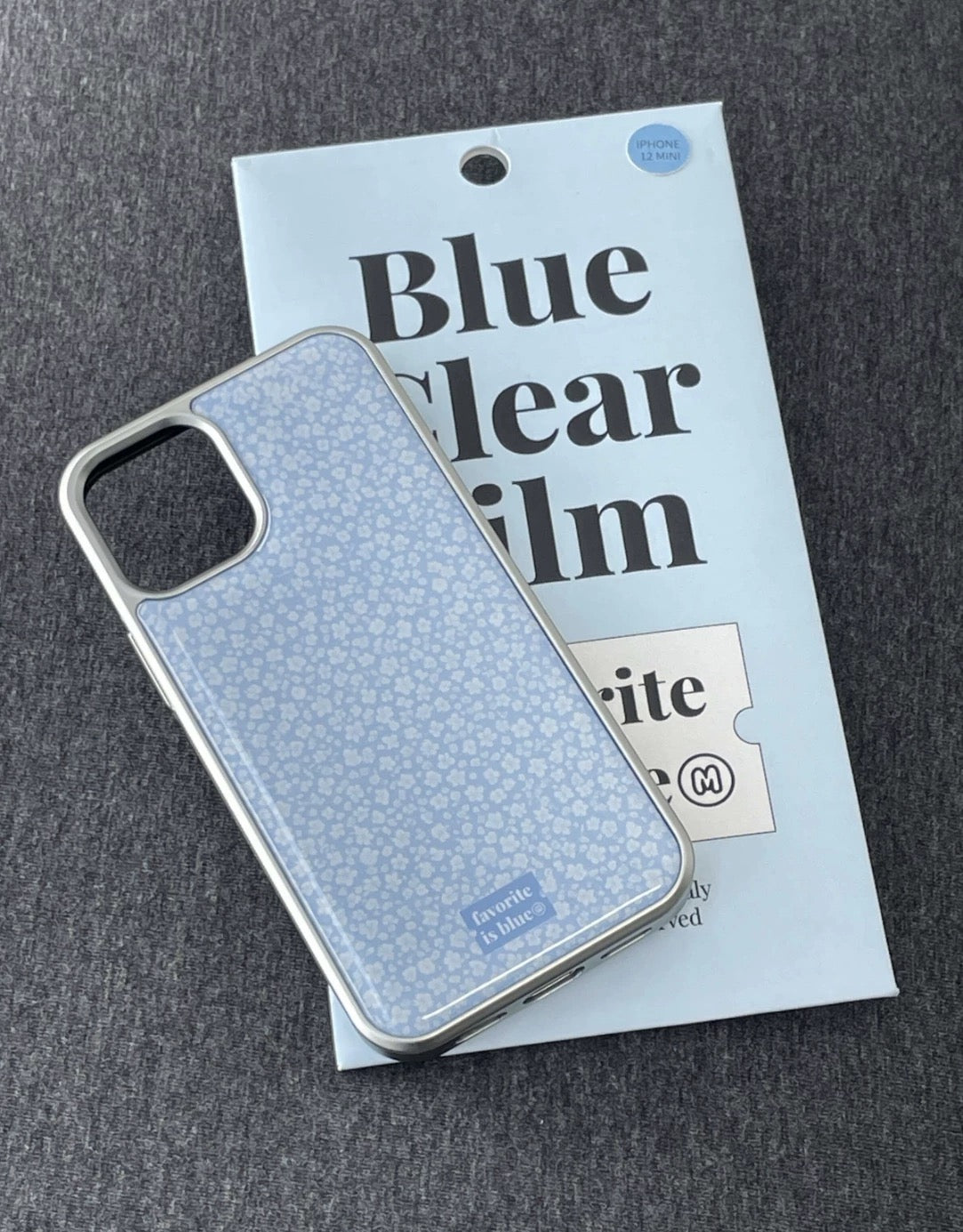 Cool blue ditsy floral iPhone case with tiny white flowers and glossy clear-edge finish detail.