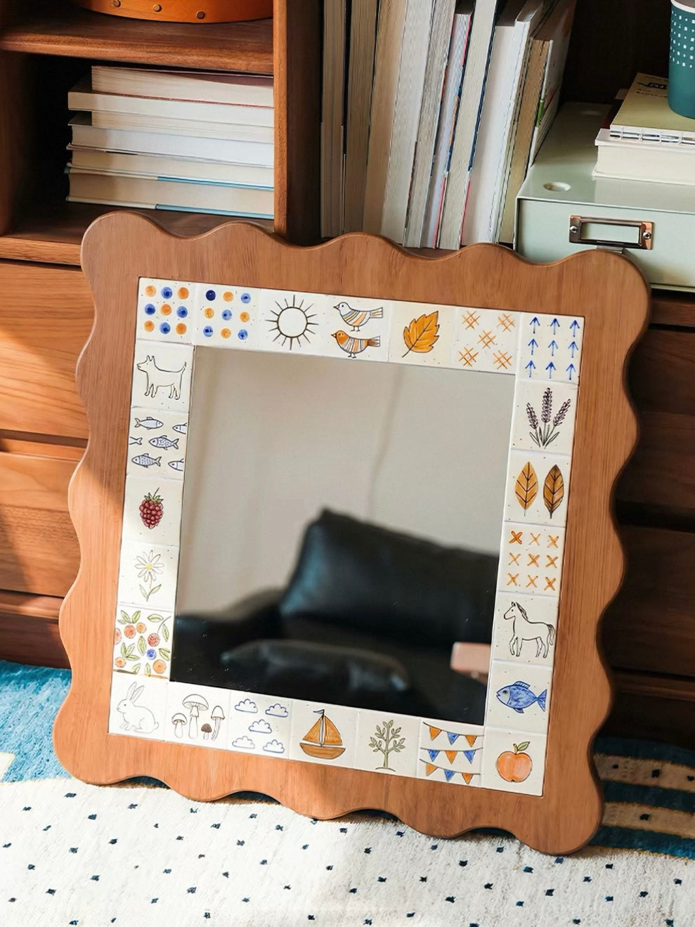 A square illustrated mirror with a brown wave edge leans beside shelves, with its full front border visible.