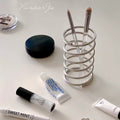Front view of stainless steel spring holder showcasing its sleek design and compact size