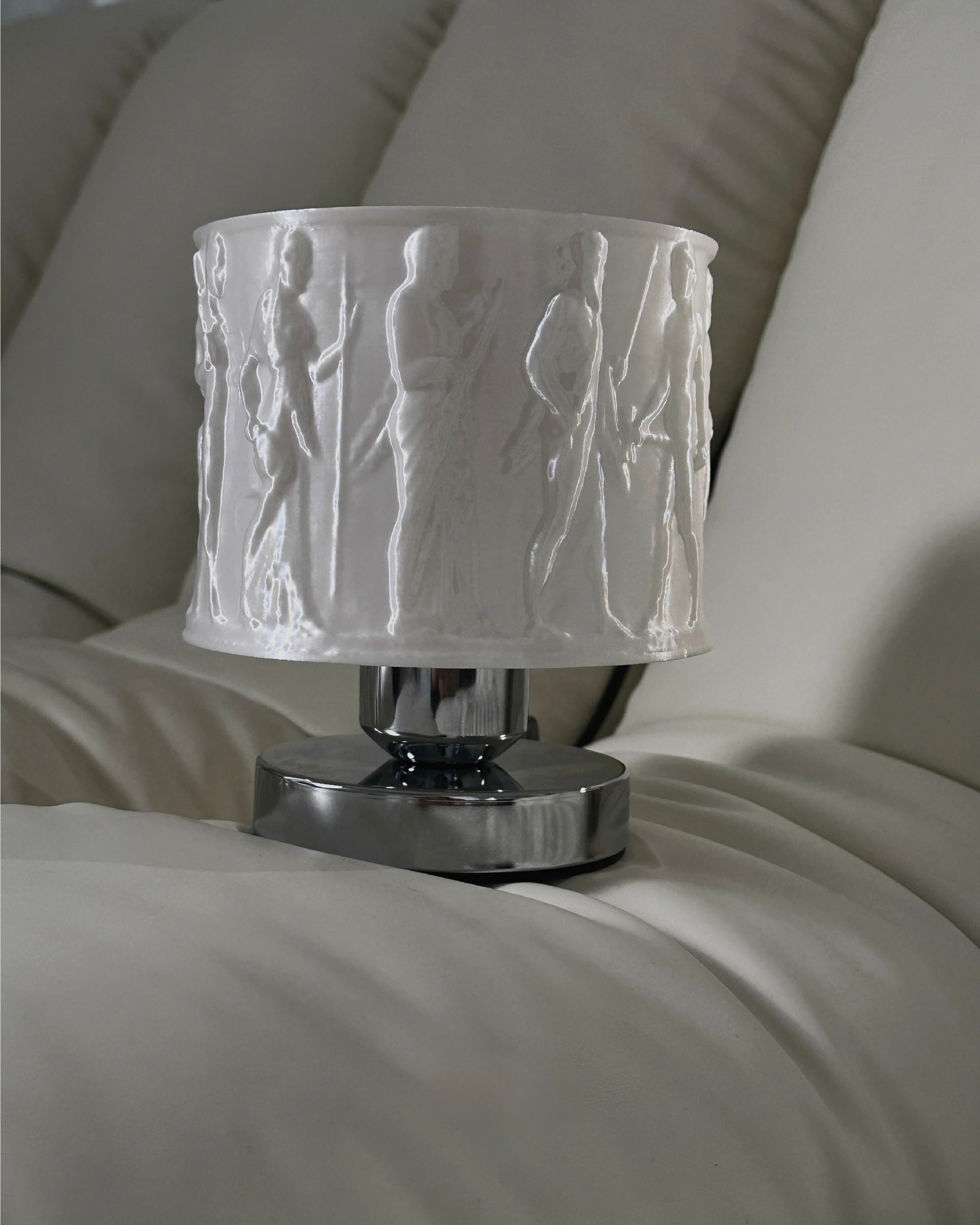 Decorative lamp with embossed design on a white surface