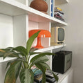 Chic orange mushroom bedside lamp with modern Bauhaus style. Perfect for bedrooms and Nordic home decor themes.