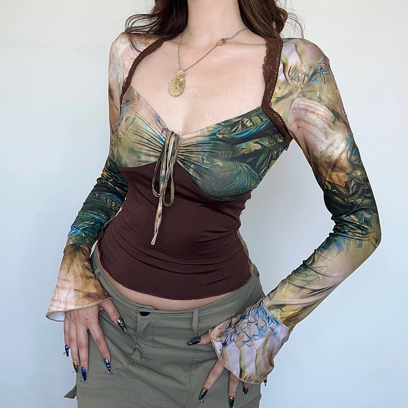 Vintage 90s crop top with Y2K aesthetic. Long sleeve tie-dye design with patchwork details, perfect for retro and cottagecore outfits.