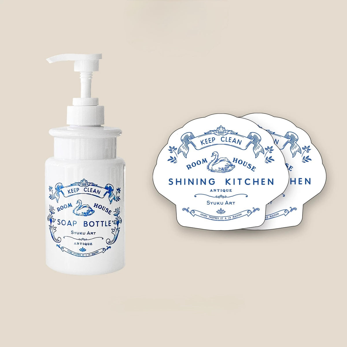 The vintage soap dispenser is shown with two matching scalloped dish sponges carrying blue swan artwork.