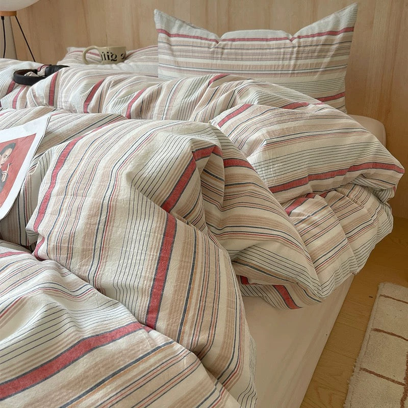 Vintage cream stripe cotton bedding set styled on neutral wooden bed in retro european minimal bedroom interior